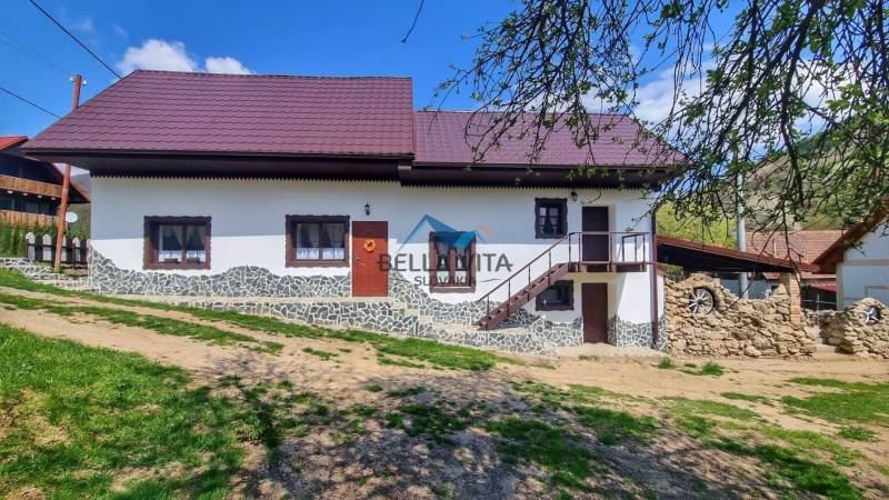 Rodinný dom v Čiernej Lehote  s drevenými oknami a kamennými detailami.