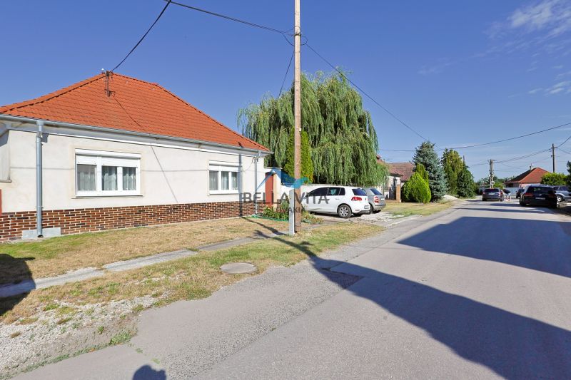 Rodinný dom v Čiernej Vode na ulici Čierna Voda, vedľa zaparkované autá a zeleň.
